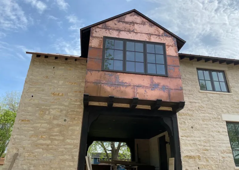 Copper metal panel facade on a stone building for Metal Roof Coating in Lewisville