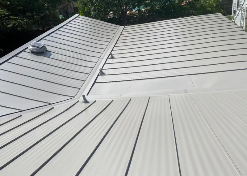 Solar attic fan installed on a metal roof for Roof Ventilation in Lewisville
